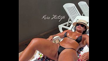 Married slut sunbathing by the hotel pool in her tiny, very daring bikini, showing off quite a bit. Kriss Hotwife